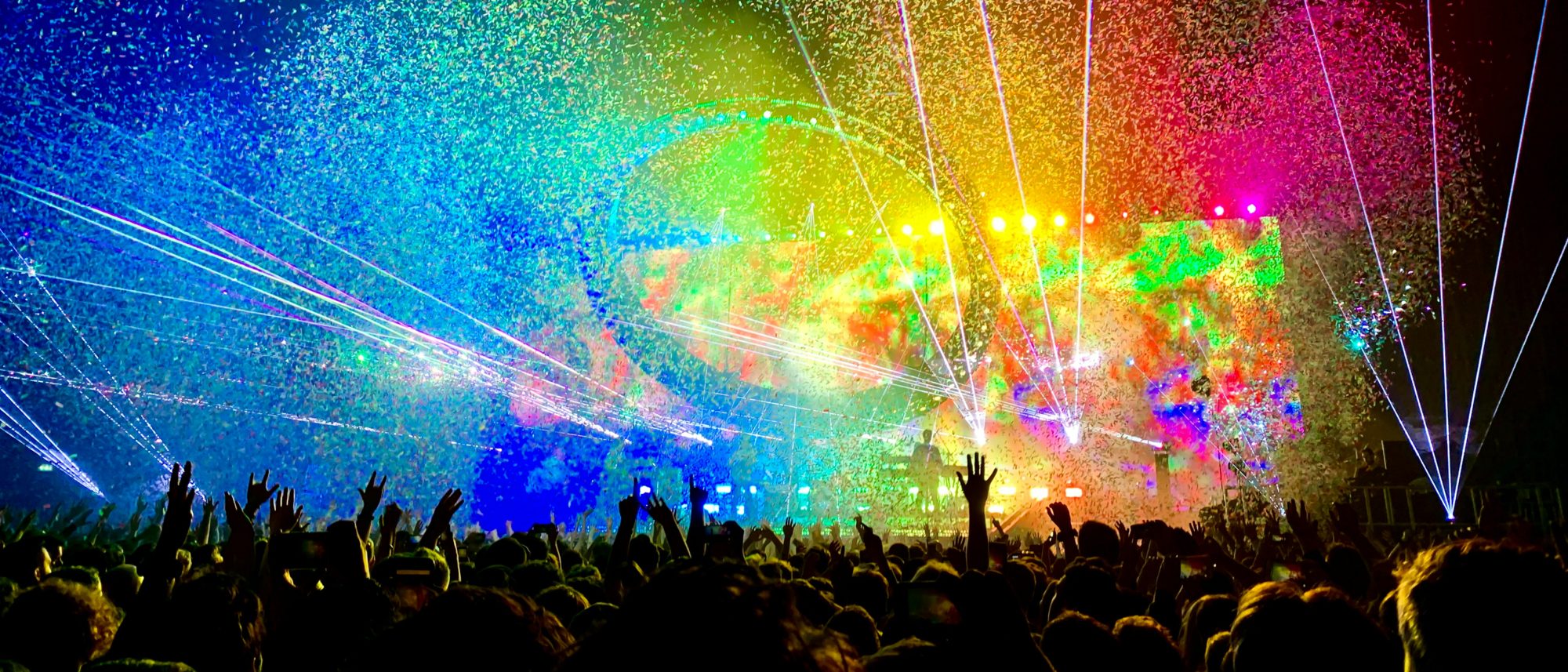 An audience at a colourful live event